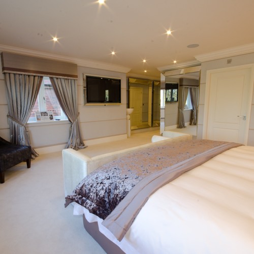 Modern, luxury master bedroom interior with soft furnishings and accessories