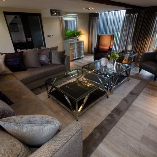 Living room contemporary Interior Design with bespoke sofa, arm chairs, table units and blinds in deep colours.