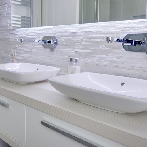 Double sink unit with soft tile tones for a modern bathroom